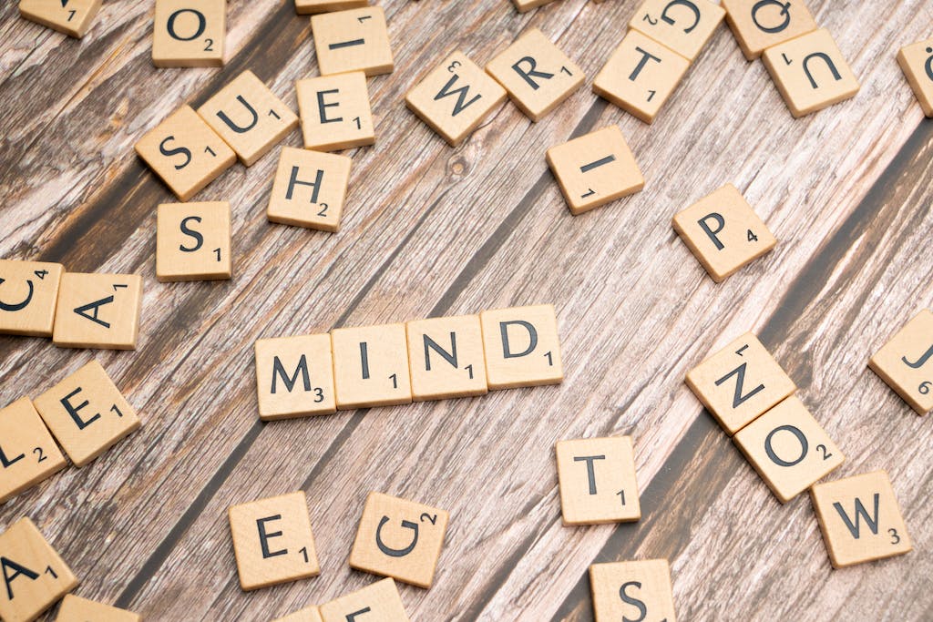 Scrabble letters spelling the word mind on a wooden table